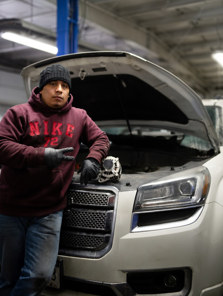 Mechanic holding tire in auto shop
